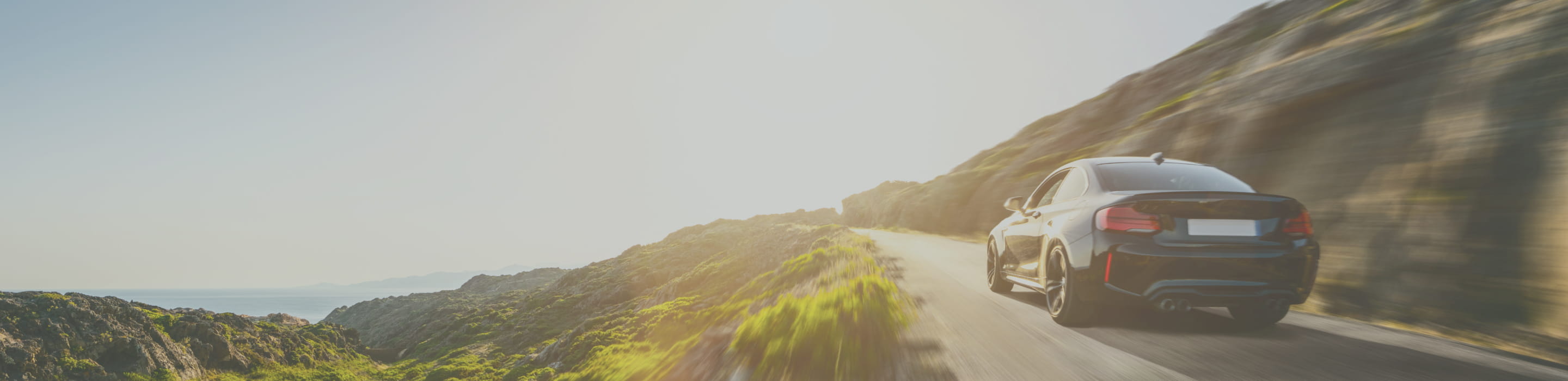 海岸沿いを走るセダン